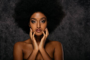 Portrait of pretty afro american woman in a studio for a beauty session - Beautiful girl posing on colored background - DMDF05041