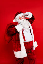 Funny Santa Claus with traditional costume on colored background - DMDF05379