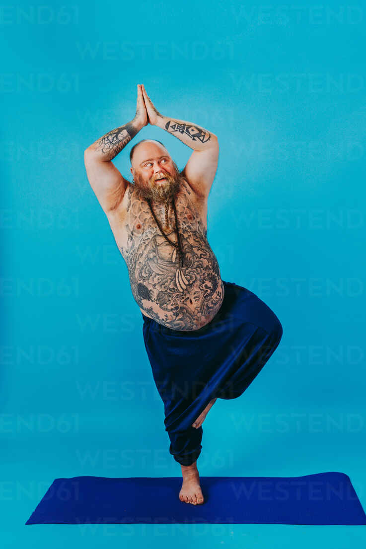 https://us.images.westend61.de/0001892460pw/funny-fat-man-doing-yoga-meditation-funny-and-ironic-character-DMDF05407.jpg