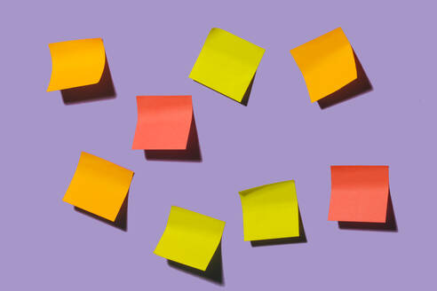 Colorful black sticky notes placed on bright violet background representing concept of idea in creative office - ADSF47247