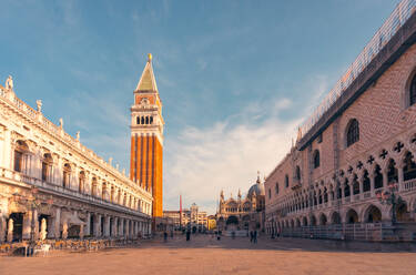 Breathtaking view of Doges Palace and Library of Saint Mark against Saint Marks Campanile bell tower of Saint Marks Basilica in Venice in sundown - ADSF47606