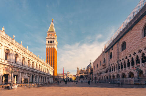 Breathtaking view of Doges Palace and Library of Saint Mark against Saint Marks Campanile bell tower of Saint Marks Basilica in Venice in sundown - ADSF47606