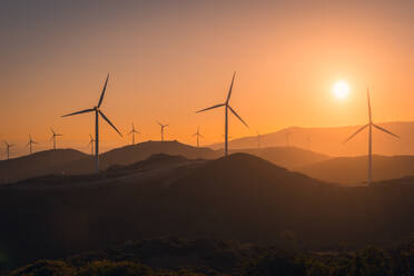 Wind generators and amazing pink heaven at sunset in blurred background - ADSF47611