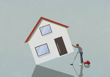 Man lifting and vacuuming under house - FSIF06585