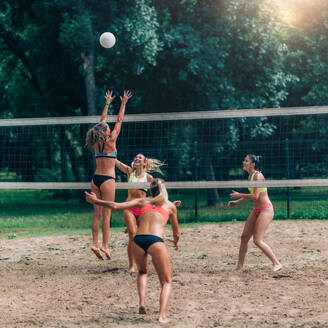 Female Team Playing Beach Volleyball - INGF12176