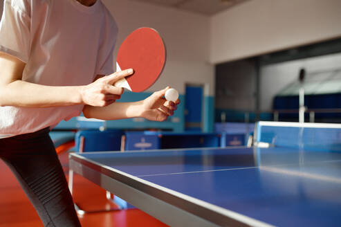 Closeup view of adult woman playing table tennis in gym. Training class at ping pong gaming club. Closeup view of adult woman playing table tennis in gym - INGF12246