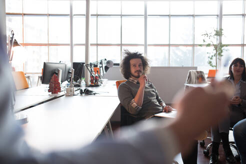 Group of a young business people discussing business plan in the office - INGF12260