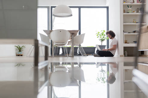 Real man Using laptop on the floor At Home Enjoying Relaxing - INGF12263