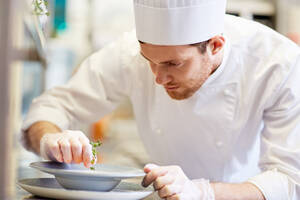 Food cooking, profession and people concept - happy male chef cook serving plate of soup at restaurant kitchen. happy male chef cooking food at restaurant kitchen - INGF12269