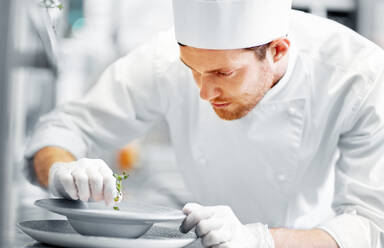 Food cooking, profession and people concept - happy male chef cook serving plate of soup at restaurant kitchen. happy male chef cooking food at restaurant kitchen - INGF12295