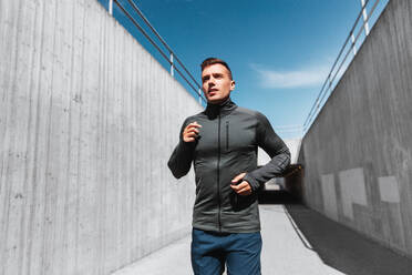 Fitness, sport and healthy lifestyle concept - young man running outdoors. young man running outdoors - INGF12335