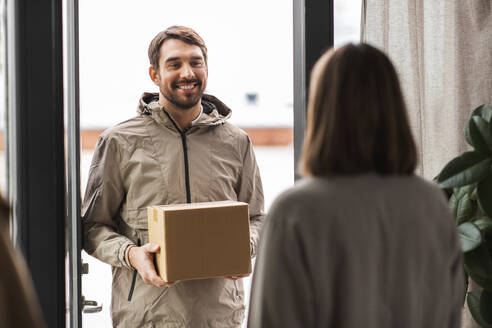 Shipping, transportation and people concept - delivery man with parcel box and customer at home. delivery man with parcel box and customer at home - INGF12337