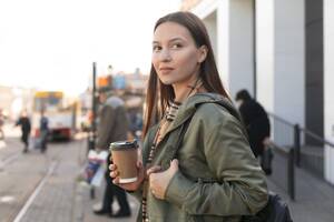 Woman waiting tramway station side view - INGF12366