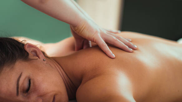 Relax massage for shoulders, hands of a massage therapist massaging shoulder of a female client - INGF12837