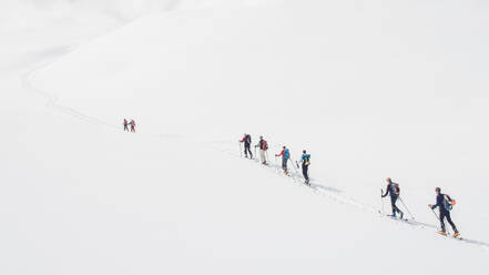 Group of ski mountaineers during an organized excursion - INGF12854