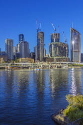 Australia, Queensland, Brisbane, Skyline of riverside city with bridge in foreground - THAF03239