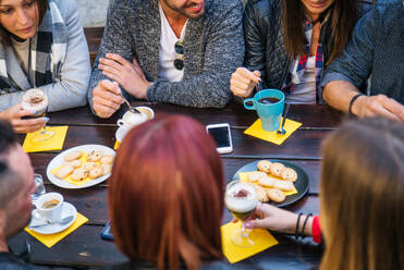 Group of friends having breakfast in a bar - DMDF05524