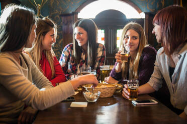 Group of happy friends having party in a bar - Young people drinking beer - DMDF05526