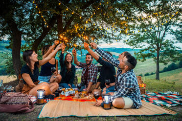 Group of young happy friends having pic-nic outdoors - People having fun and celebrating while grilling ata barbacue party in a countryside - DMDF05657
