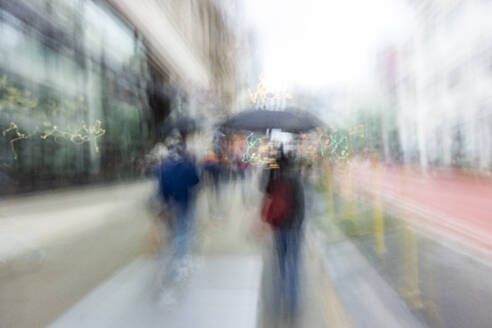 Blurred image of people walking on city street - TETF02272