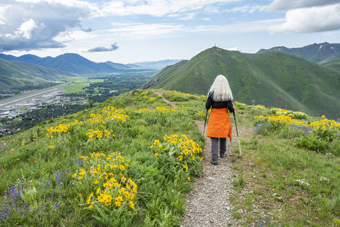 USA, Idaho, Hailey, Senior blonde woman hiking on Carbonate Mountain trail - TETF02280