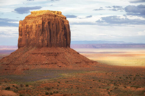 Rocky formation located on vast terrain in Monument Valley under cloudy sky full of clouds in America - ADSF47951
