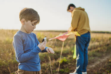 Father and son with kite in field - ANAF02169