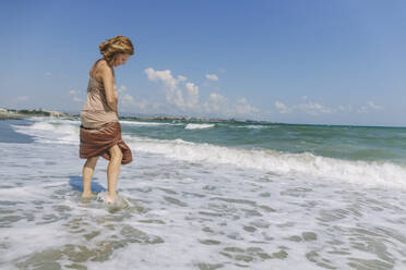 Frau steht am Ufer am Strand - SIF00940