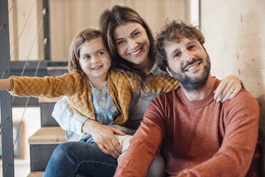 Happy parents with daughter sitting at home - JOSEF21057