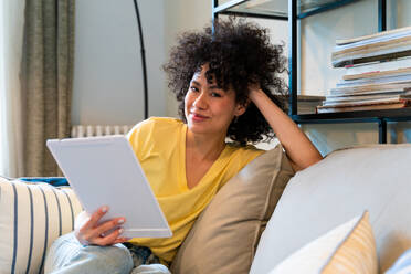 Beautiful latino young woman at home - Pretty south american with curly hair female portrait, lifestyle and domestic life scene - DMDF05783