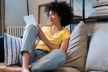 Beautiful latino young woman at home - Pretty south american with curly hair female portrait, lifestyle and domestic life scene - DMDF05785