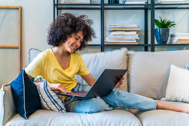 Beautiful latino young woman at home - Pretty south american with curly hair female portrait, lifestyle and domestic life scene - DMDF05791