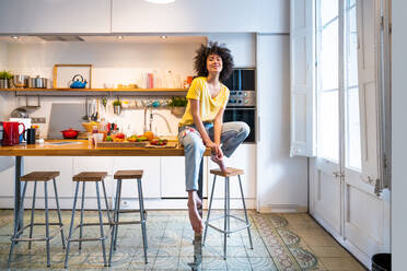 Beautiful latino young woman at home - Pretty south american with curly hair female portrait, lifestyle and domestic life scene - DMDF05804