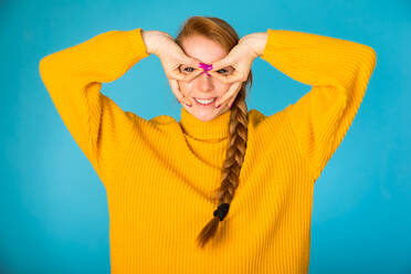 Porträt einer attraktiven Frau während einer Schönheitsbehandlung im Studio - Schöne Pose auf farbenfrohem Hintergrund - DMDF06138