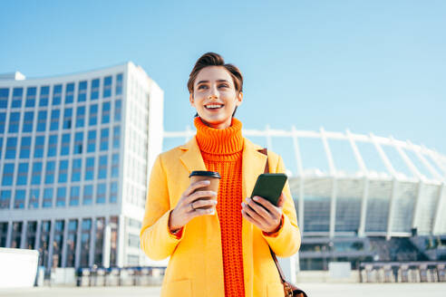 Beautiful young woman with short hair in the city - Pretty caucasian female adult business woman wearing elegant suit going to work in the office - DMDF06490