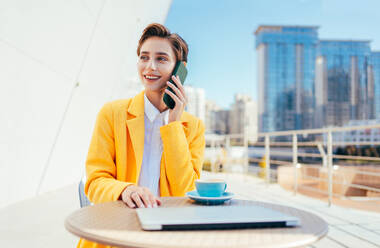 Beautiful young woman with short hair in the city - Pretty caucasian female adult business woman wearing elegant suit going to work in the office - DMDF06503