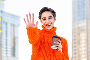 Beautiful young woman with short hair in the city - Pretty caucasian female adult business woman wearing winter sweater - DMDF06513