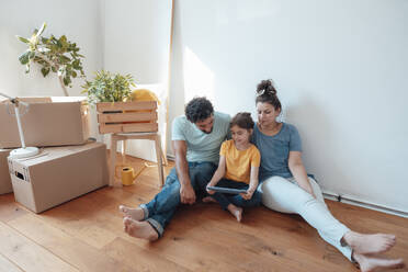 Parents with daughter using tablet PC on floor at home - JOSEF21209