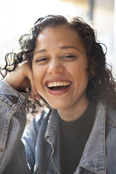 Glückliche junge Frau lachend an einem sonnigen Tag - AMWF01788