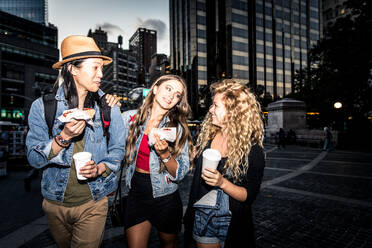 Multi-ethnic group of friends bonding outdoors - Young people walking and talking on the streets - DMDF06641