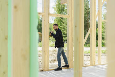 Engineer working on wood at construction site - SEAF02012