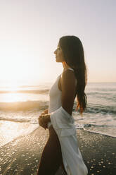 Thoughtful woman standing near sea at beach - SIF01019