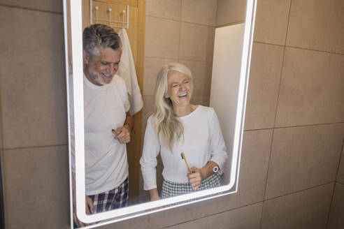 Happy couple laughing in bathroom at home - JCCMF10766