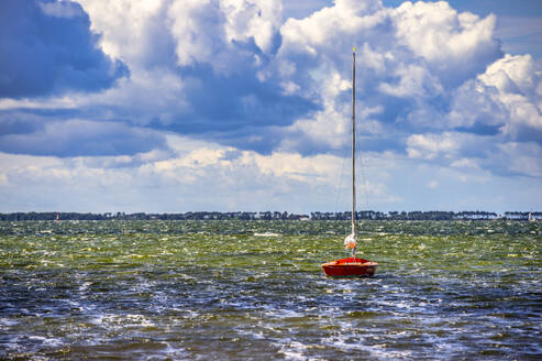 Germany, Mecklenburg-Vorpommern, Schaprode, Clouds over sailboat floating in Baltic Sea - FRF01027