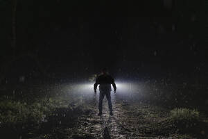 Silhouette Dämon stehend im Wald bei Nacht während der Regenzeit - MASF39616