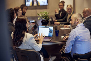 Multiracial business professionals discussing during conference call in board room - MASF39890