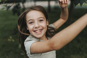 Portrait of cheerful girl dancing at park - MASF39920