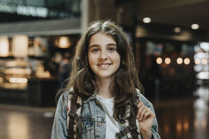 Portrait of smiling girl with backpack at station - MASF40032