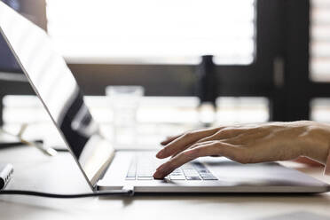 Hands of businesswoman typing on laptop - PESF04077