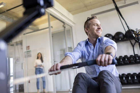 Happy businessman exercising in office gym - PESF04095